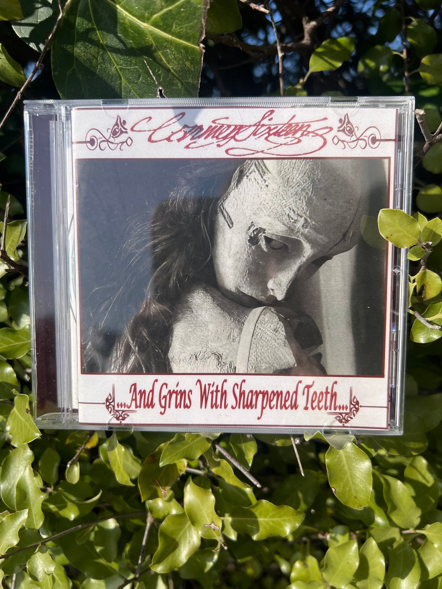 Carmen Sixteen “…And Grins With Sharpened Teeth…” CD